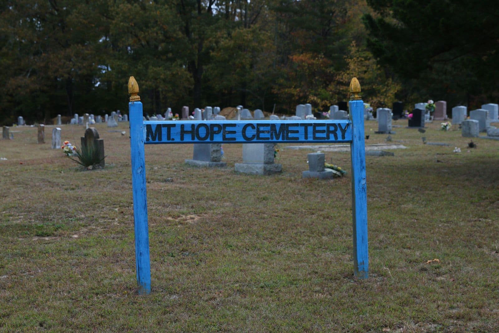 Family honoring a restored historic African American gravestone